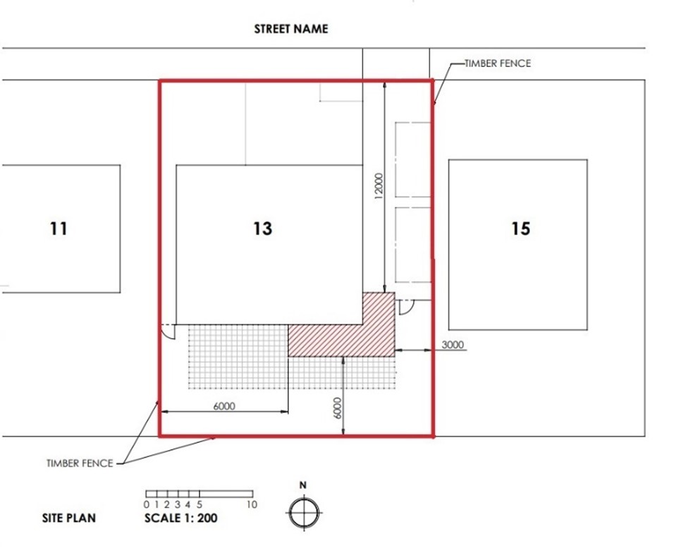 An example of an acceptable proposed site plan. The plan is focused on a building labelled 13. The timber fence surrounding it is outlined in red. Hard surfaces are identified with a black grid and a red hashed area.  The scale bar at the bottom of the image is 1:200 and the north compass is next to it.